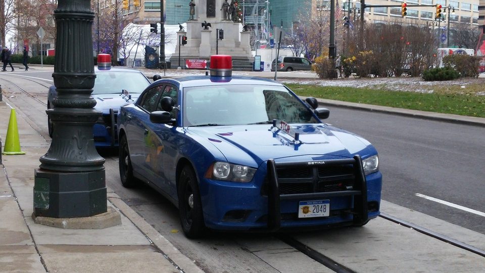 Two blue Michigan State Police cars in downtown Detroit