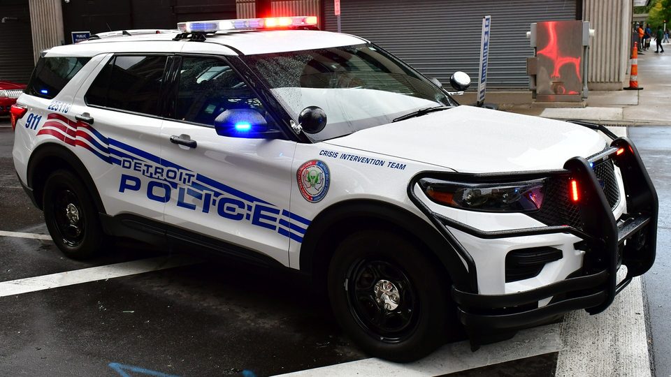 A Detroit Police SUV with its light bar on