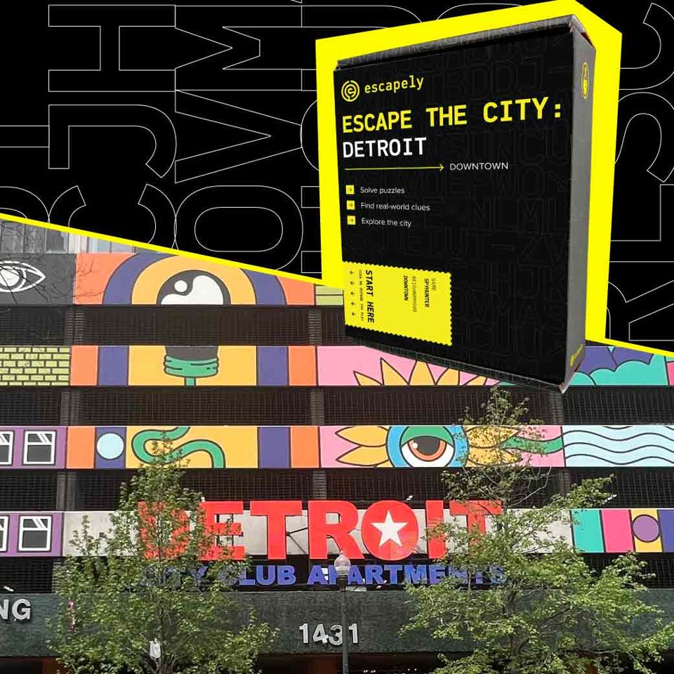 The Escape the City: Detroit game box in front of the colorful mural and red DETROIT sign of City Club Apartments downtown