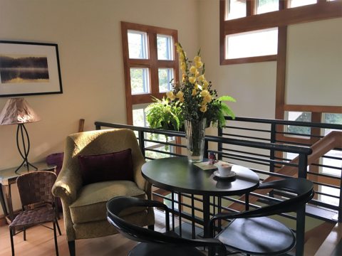 A sitting nook with a table and plant inside the house