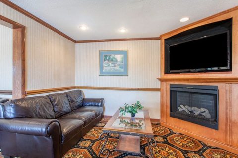 A lounge with a fireplace and TV