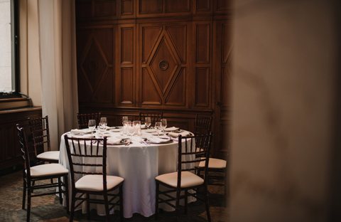 A set round table in the wood-paneled private dining room
