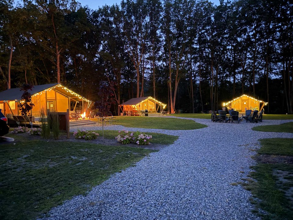 Megvilágított glamping sátrak este az ösvény mentén