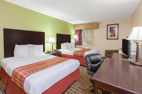 A room with two beds and a desk