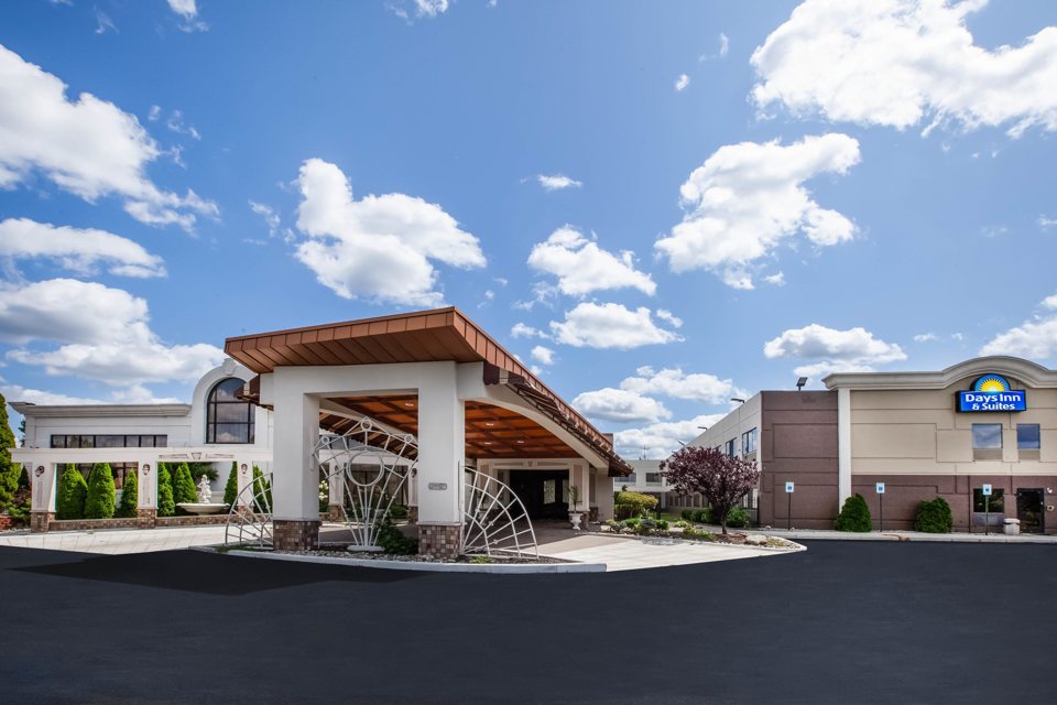 The hotel entrance with canopy and sign