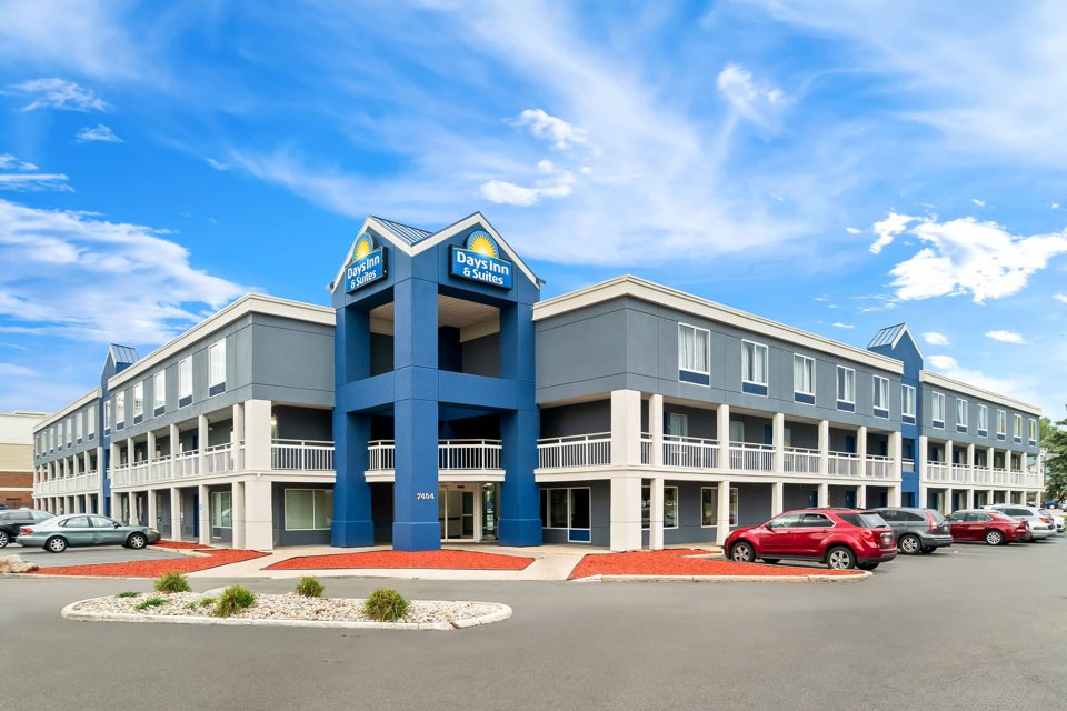 The three-storey blue and gray hotel in sunshine