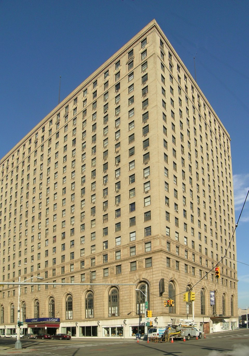A Detroit-Leland Hotel magas, bézs téglás tömbje a Bagley Streeten 2008-ban, kék ég alatt