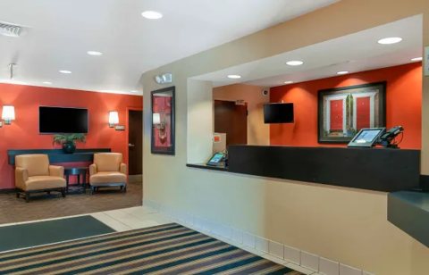 The front desk and lobby seating area with orange walls