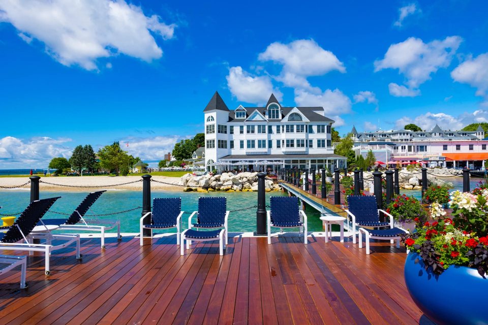 The hotel's own dock with blue loungers and the white turreted hotel building behind it under a blue sky