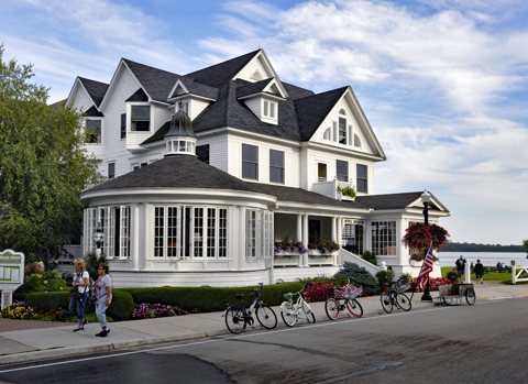 The hotel's white Victorian building with its rounded porch on Main Street, with bicycles out front