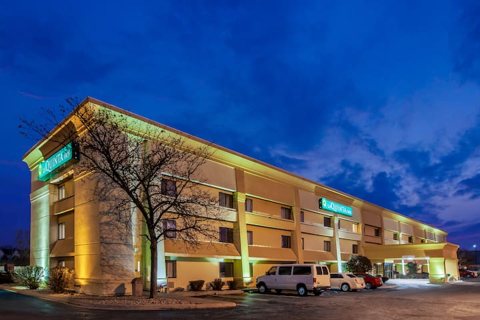 The hotel building lit up at dusk