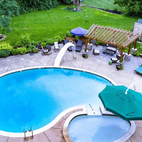 The garden pool with umbrellas and a pergola