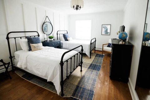 A guest room with a metal-frame bed