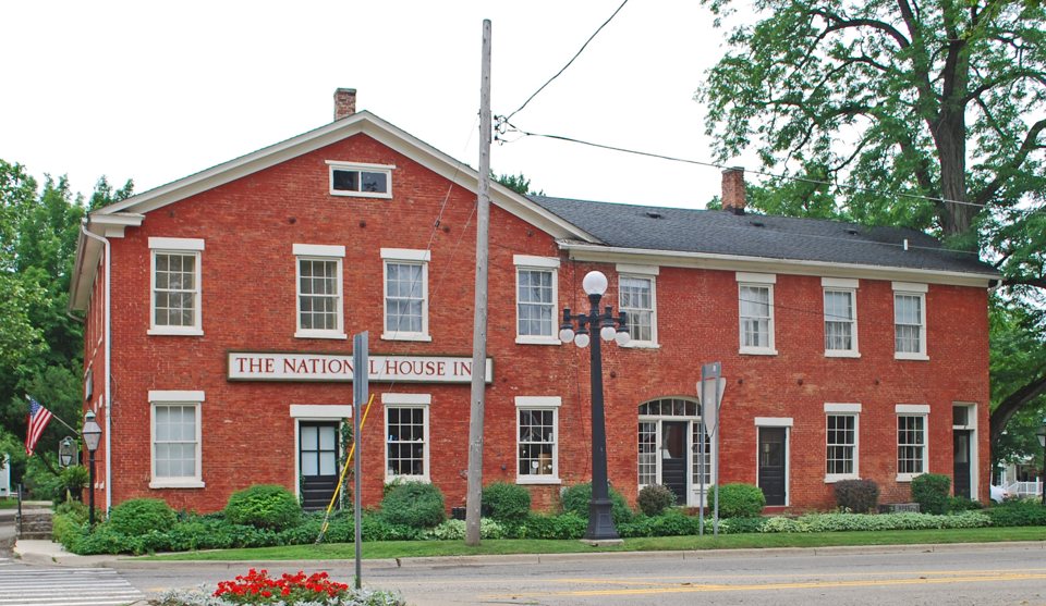 The National House Inn's two-story red brick building with white window frames and its name sign in Marshall