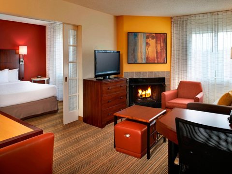 Guest room with a fireplace and seating area