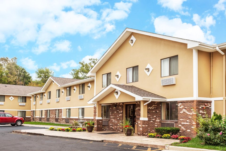 The motel's yellow facade under blue sky