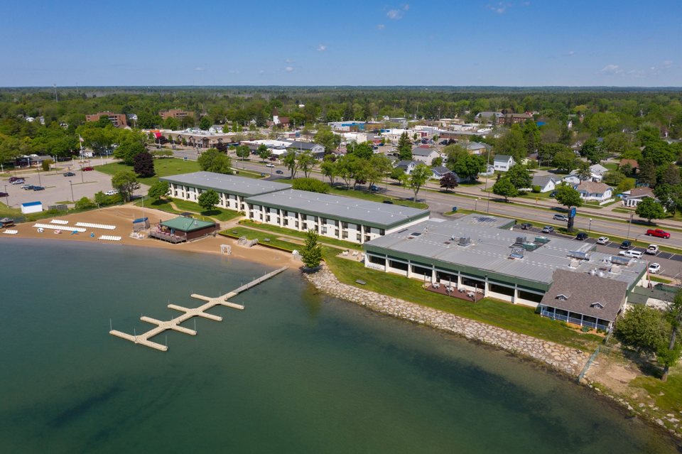 Aerial view of the lakeside hotel buildings, the beach and the dock
