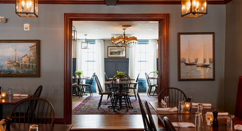 The tavern's wood-trimmed dining room with lanterns and paintings