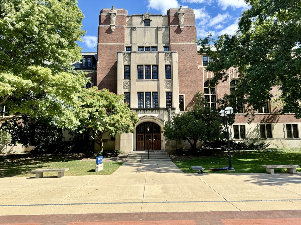 The Michigan League's brick and stone building with its main entrance and trees; the inn is inside it