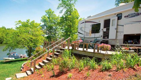 An RV beside the water with stairs