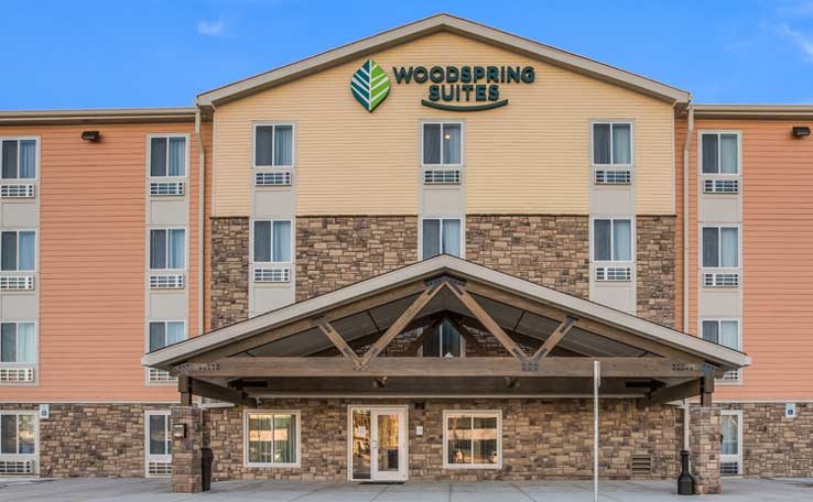 The hotel's three-storey facade with a timber entrance canopy