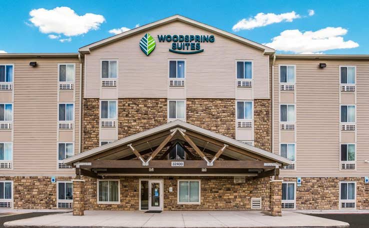 The hotel facade with stone and timber trim