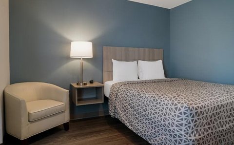 Guest room with a bed and blue wall