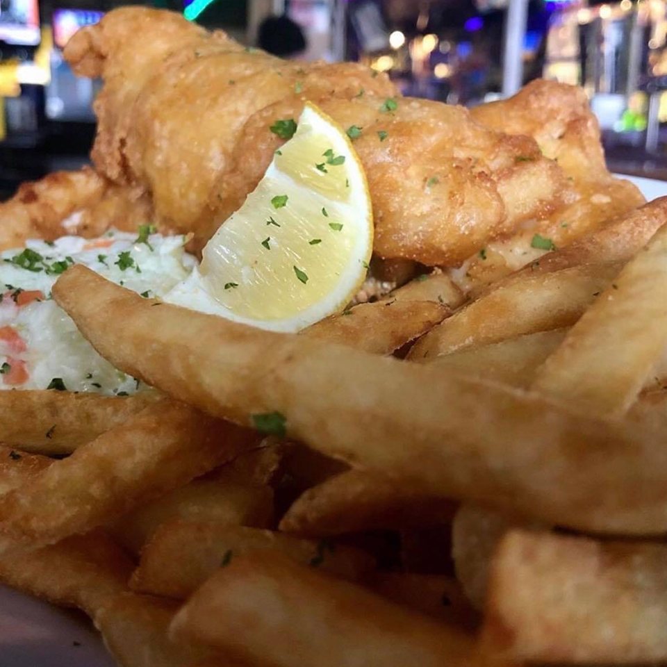 Fried fish with fries and a lemon wedge