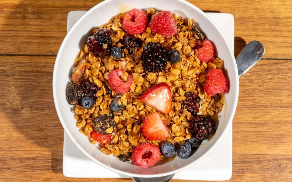Granola bowl topped with fresh berries
