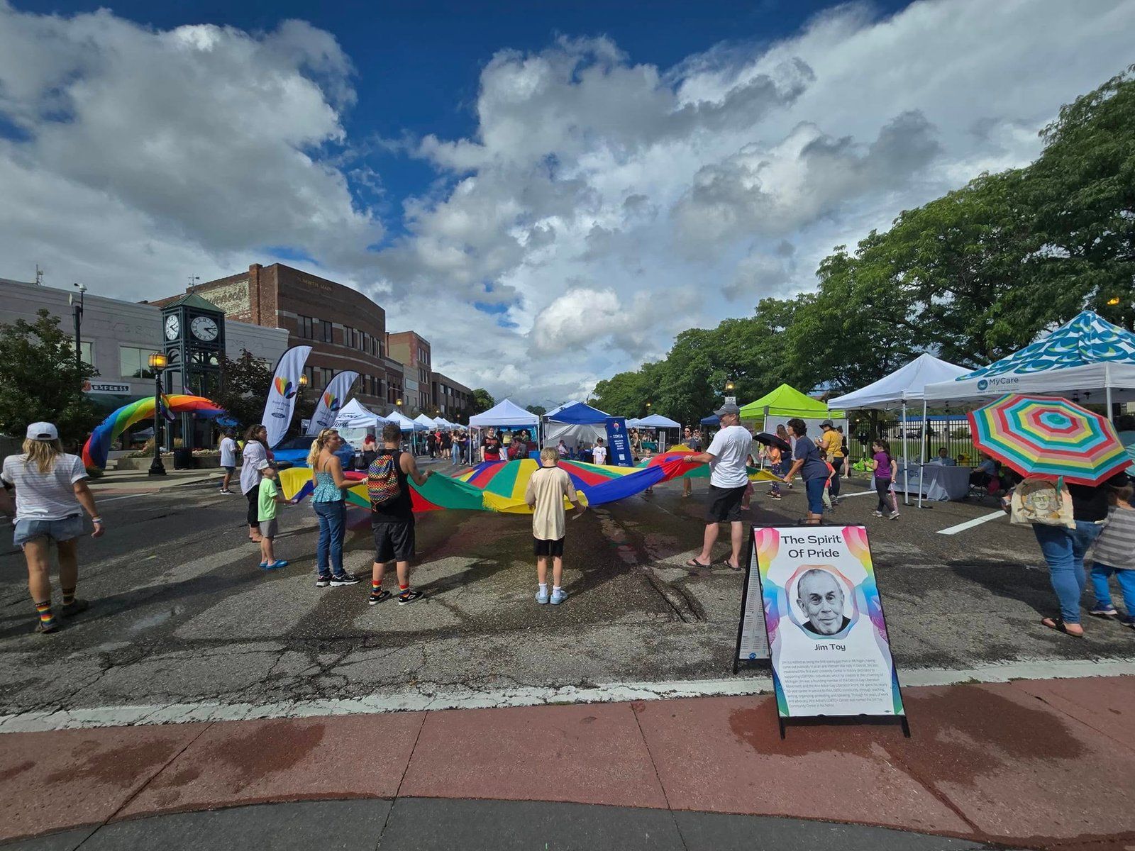 Tents and a rainbow parachute at the Macomb County Pride street festival