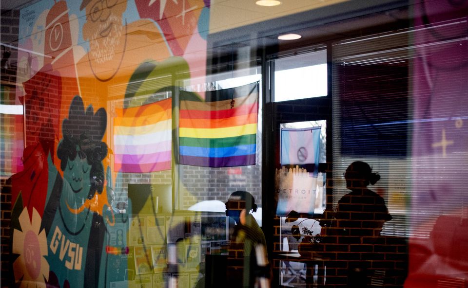 The center's glass front with a colorful mural, a rainbow flag and a transgender flag