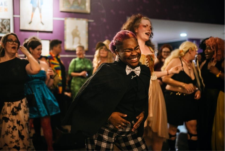 Guests dancing joyfully at an Affirmations event