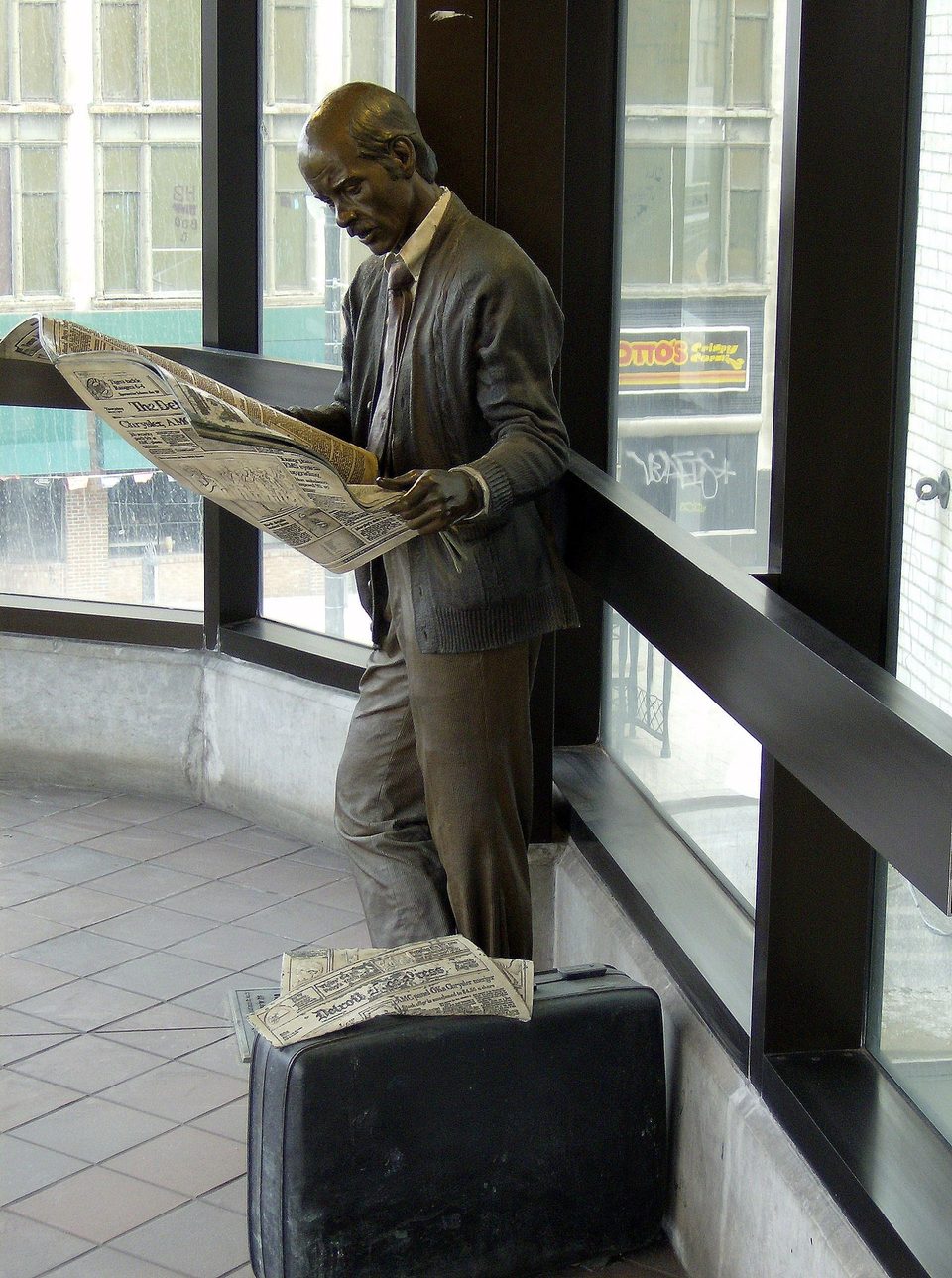 J. Seward Johnson’s bronze “Catching Up”: a commuter reading his newspaper