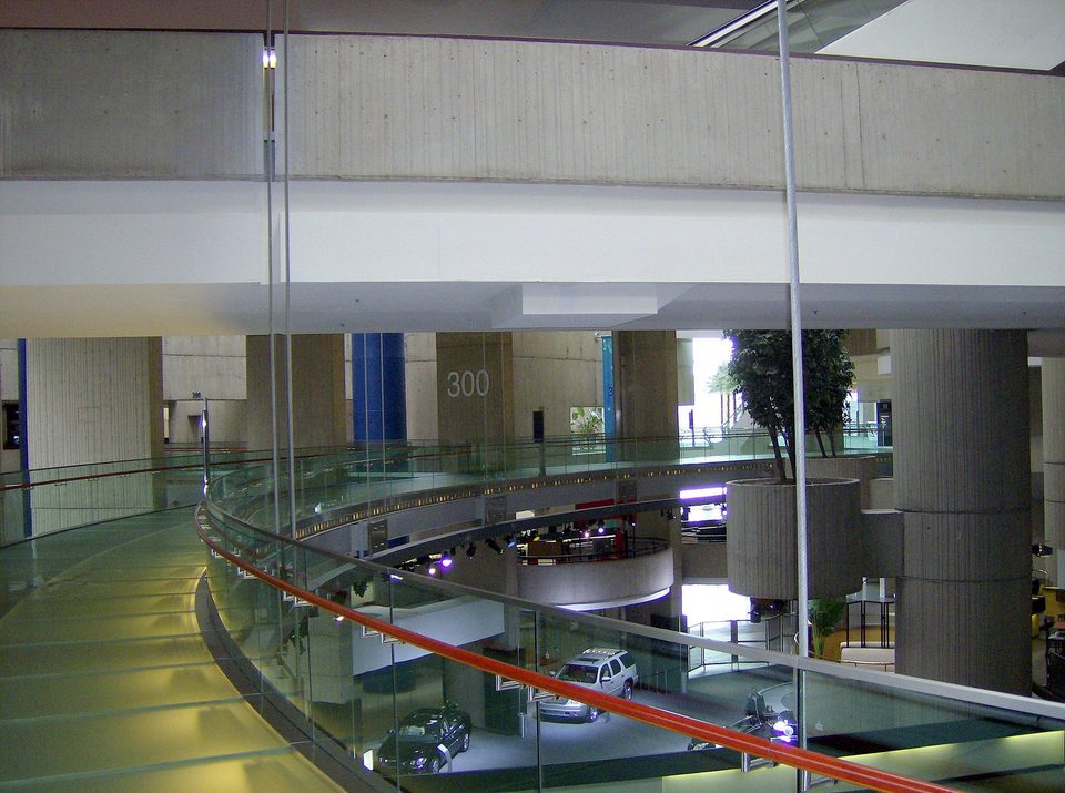 A tornyokat összekötő körfolyosó, a „circulation ring” üvegpadlós szakasza a 300-as torony jelzésénél 2007-ben; lent GM-autók