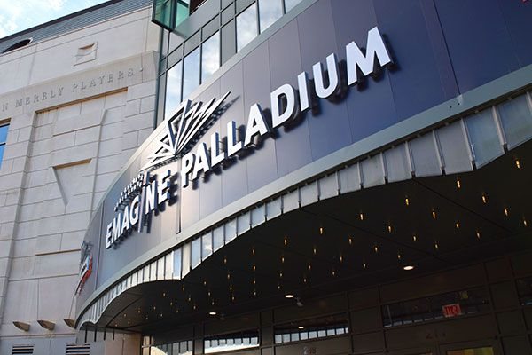 The Emagine Palladium sign above the building's curved canopy dotted with small lights