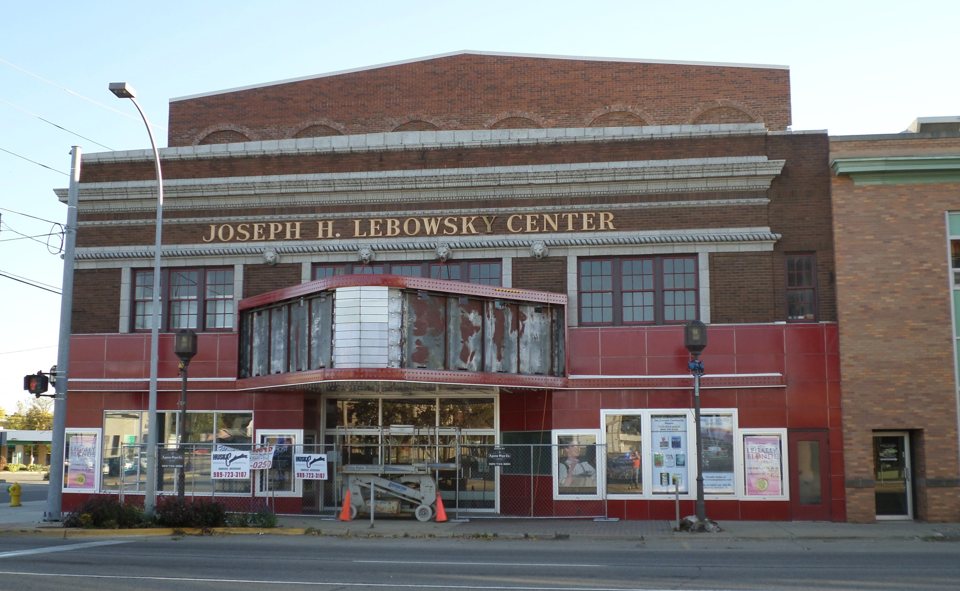 The red-brick facade of the Joseph H. Lebowsky Center on Owosso's Main Street, its marquee under renovation