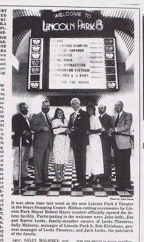 Old newspaper clipping of officials at the ribbon-cutting in front of the new Lincoln Park 8 showtime board