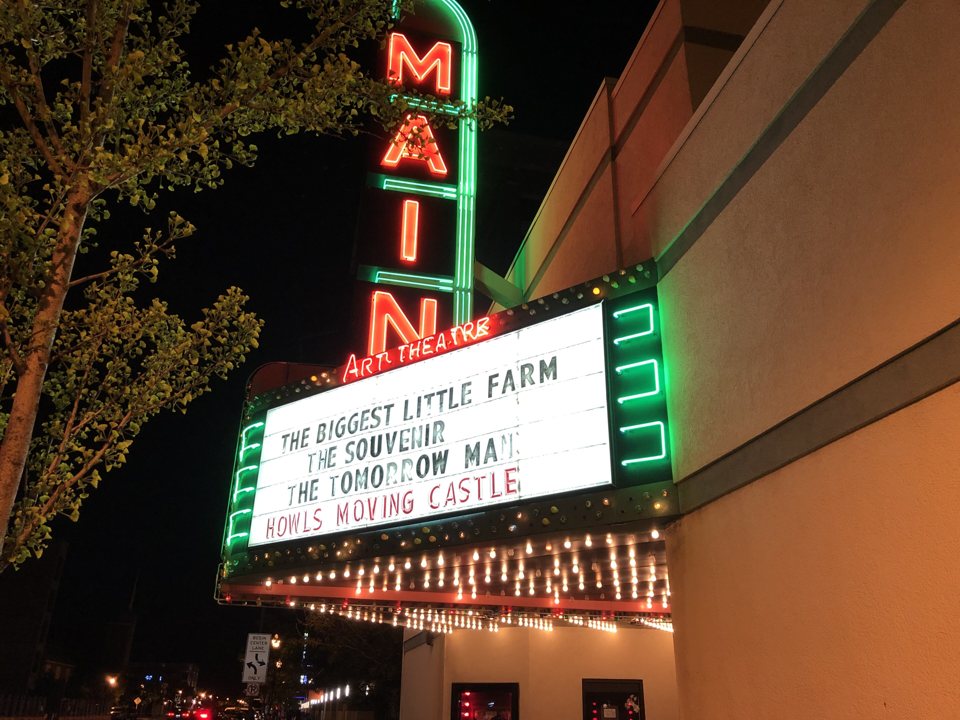 The Main Art's original 1941 marquee and red vertical MAIN neon sign lit up at night