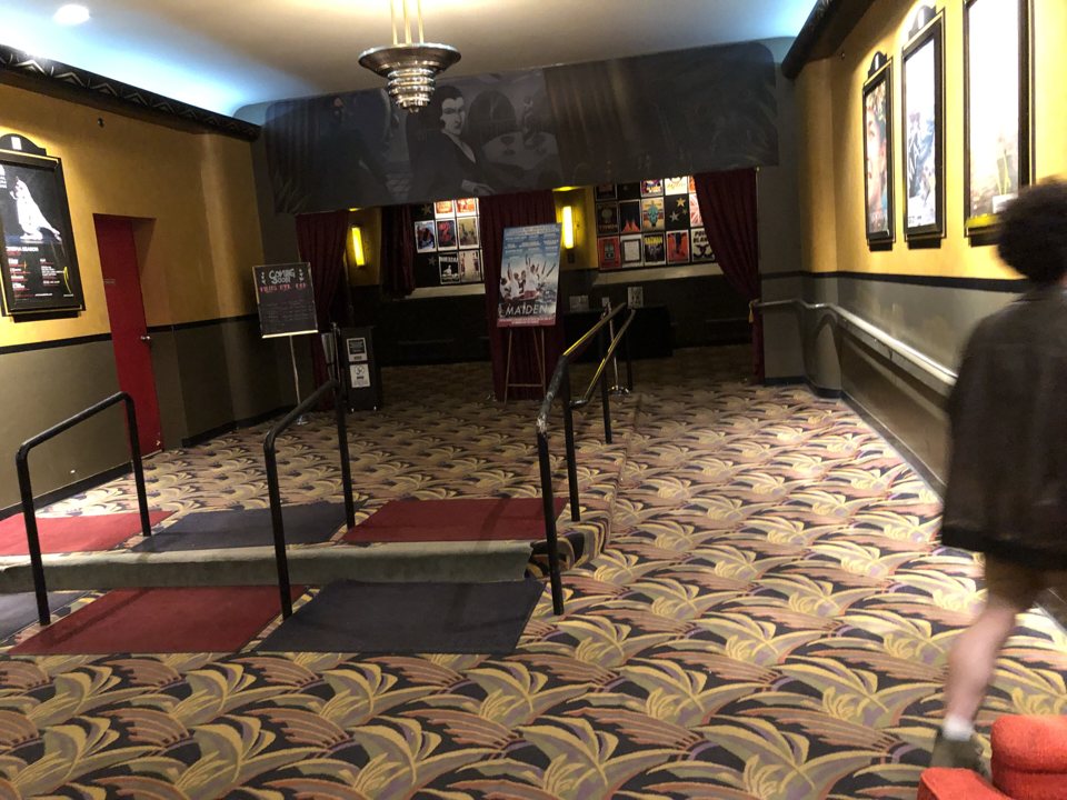 The Main Art lobby with patterned carpet, poster frames and railings