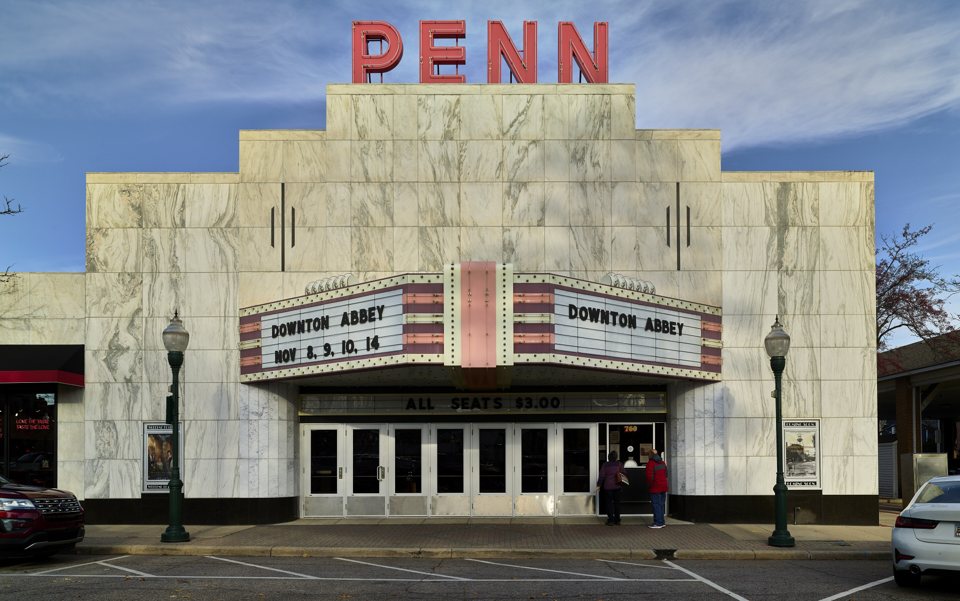 The Penn Theatre's marble-clad Art Deco facade with its red PENN neon sign and marquee in downtown Plymouth