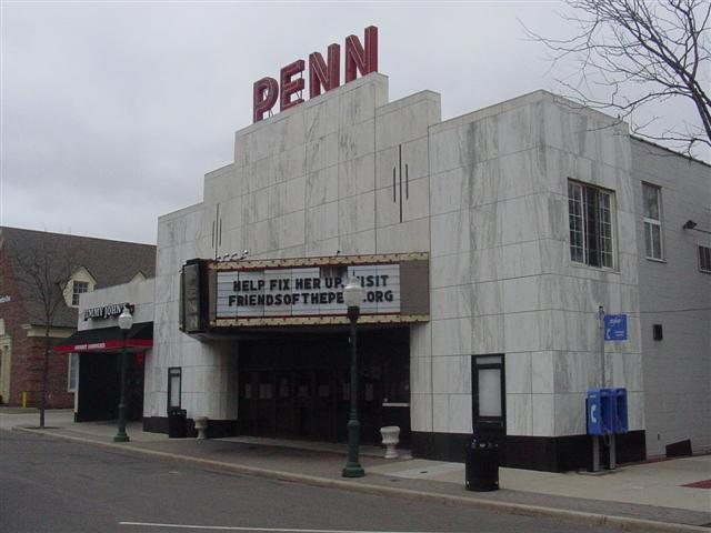 The Penn Theatre's facade and marquee seen at an angle from the Penniman Avenue sidewalk