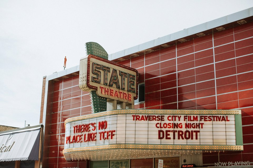 The State Theatre's red tiled facade and marquee announcing the Traverse City Film Festival closing night film, Detroit