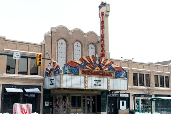 The brick facade with arched windows, the vertical sign and the colorful sunburst marquee in winter