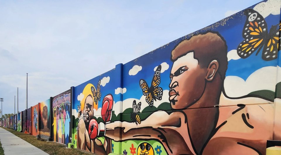 Bikes leaning against a vivid mural on a Detroit street