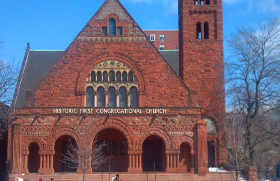 The red-brick Gothic building of First Congregational Church against a blue sky in Detroit