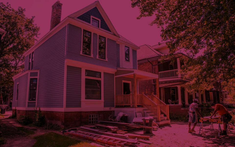 Volunteers work on renovating a house in the Woodbridge neighborhood